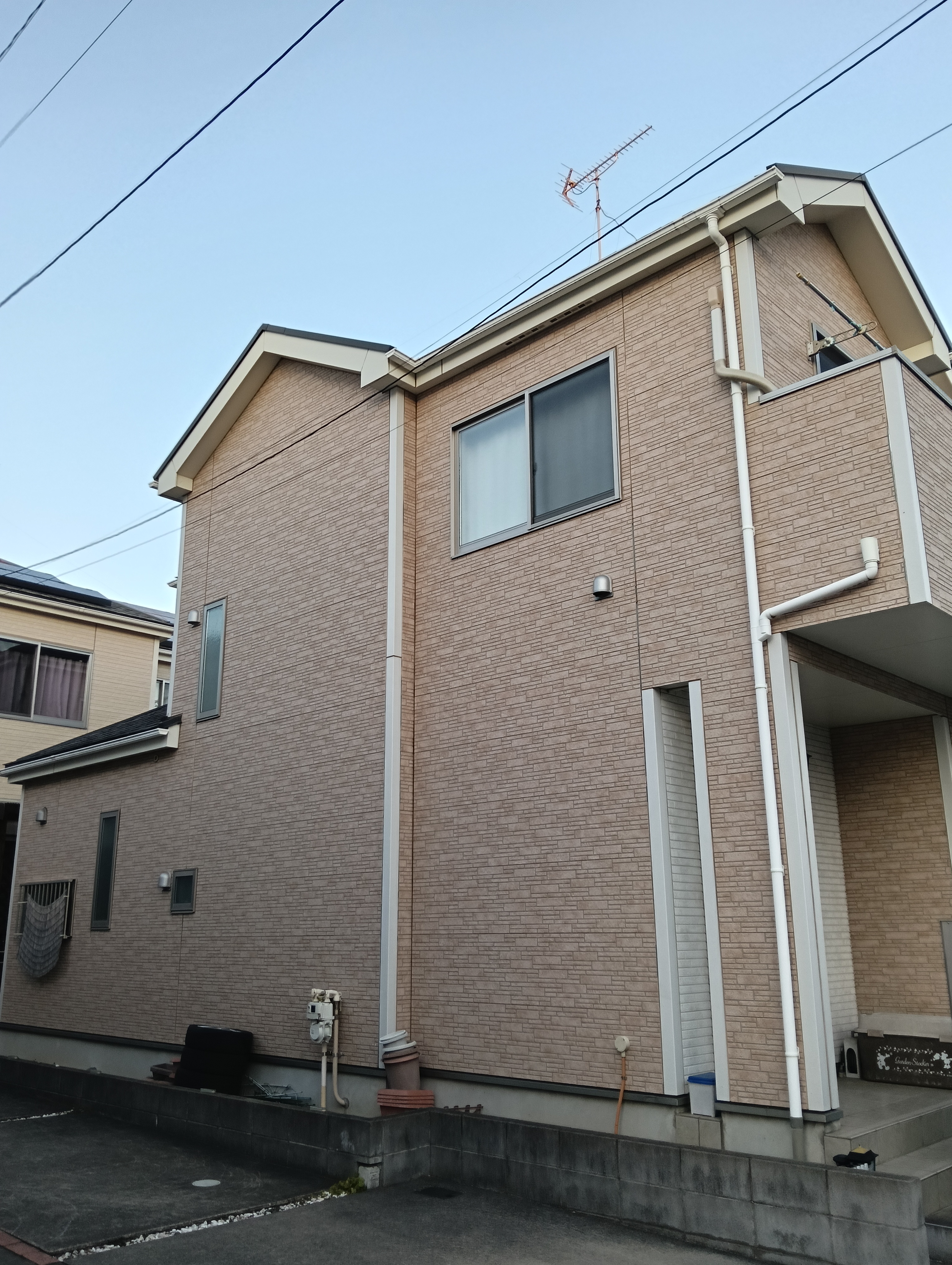 【施工前】川口市K様邸の外壁。経年劣化による色あせやシールのひび割れが見受けられ、塗り替えが必要な状態の全景。